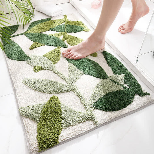 Bare feet standing on the green leaf mat at the edge of a shower tray.