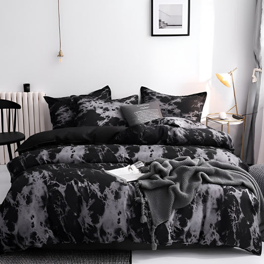 A bed made up with a black marble duvet cover and two matching pillowcases in a white bedroom.