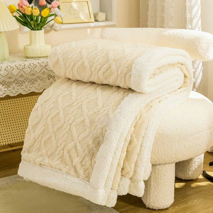 Cream sherpa throw blanket folded, the raised cable and diamond texture facing out