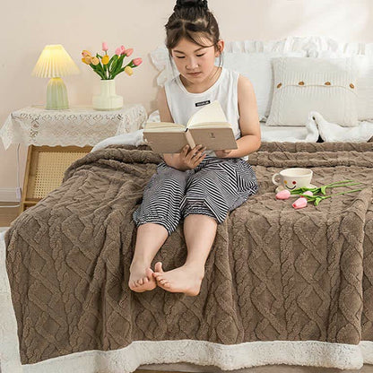 A child holding the brown sherpa throw blanket