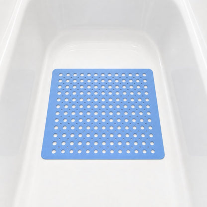 A blue square shower mat sitting in the bottom of a white bath