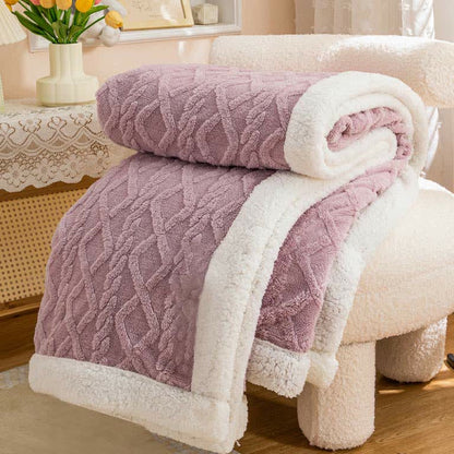Mauve sherpa throw blanket folded, the raised cable and diamond texture facing out