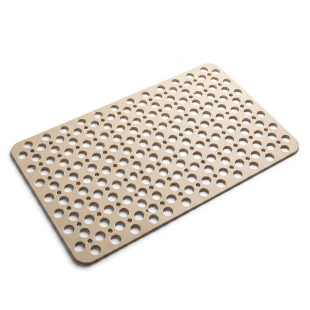 A beige shower mat photographed at an angle on a plain white background
