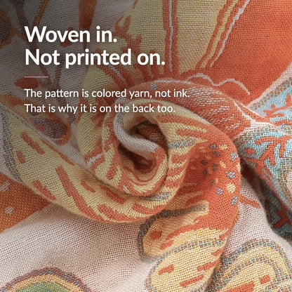 Claim card reading Woven in. Not printed on. Over a close photograph of the cloth rolled at a fold, showing the pattern made of colored threads.